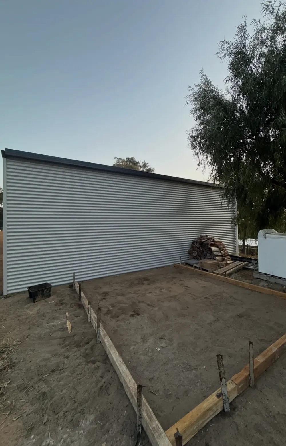Timber formwork boxed out in front of a shed, ready for a slab
